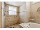 Bathroom with tiled shower, corner tub, and a window for natural light at 481 W Holly Dr, Orange City, FL 32763