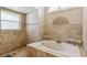 Close-up of a luxurious bathroom with a soaking tub and a walk-in shower at 481 W Holly Dr, Orange City, FL 32763