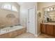 Bathroom featuring a soaking tub, tiled floors and walls, and a dual sink vanity at 481 W Holly Dr, Orange City, FL 32763
