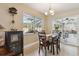 Dining room adjacent to sliding door features tile floors, a chandelier, and views of screened patio at 481 W Holly Dr, Orange City, FL 32763