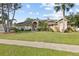 Charming single-story home with well-manicured lawn and mature trees showcasing curb appeal at 481 W Holly Dr, Orange City, FL 32763