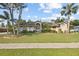 Charming single-story home with well-manicured lawn and mature trees showcasing curb appeal at 481 W Holly Dr, Orange City, FL 32763