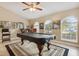 Well-lit game room featuring a pool table, barstool seating and arched windows with natural lighting at 481 W Holly Dr, Orange City, FL 32763
