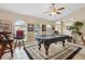 Spacious game room with a pool table, high ceilings, and arched windows for ample natural light at 481 W Holly Dr, Orange City, FL 32763