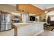 Spacious kitchen features stainless steel appliances, a center island, and an open floor plan into the living area at 481 W Holly Dr, Orange City, FL 32763
