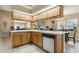 Kitchen with stainless steel appliances, island with bar seating, tile floors and lots of natural light at 481 W Holly Dr, Orange City, FL 32763