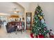 Open-concept living space with Christmas tree, adjacent to dining area and kitchen, and tile floors at 481 W Holly Dr, Orange City, FL 32763