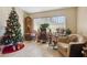 Cozy living area features a Christmas tree, grandfather clock, rocking chairs, and neutral decor at 481 W Holly Dr, Orange City, FL 32763