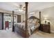 Main bedroom features a four-poster bed, neutral carpeting, and access to the screened in porch at 481 W Holly Dr, Orange City, FL 32763