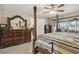 Main bedroom with neutral carpet features a large mirror on the dresser and access to screened porch at 481 W Holly Dr, Orange City, FL 32763