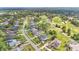 Extensive aerial view of a golf community with lake views, many homes, and mature trees at 483 N Pine Meadow Dr, Debary, FL 32713