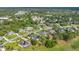 Aerial view of home and neighborhood showcasing a serene setting amongst lush green trees at 483 N Pine Meadow Dr, Debary, FL 32713