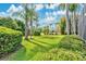Lush backyard features a mix of green grass, mature trees, and manicured bushes at 483 N Pine Meadow Dr, Debary, FL 32713