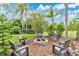 Beautifully landscaped backyard with a cozy fire pit area, perfect for outdoor gatherings and relaxation at 483 N Pine Meadow Dr, Debary, FL 32713