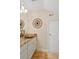 Modern bathroom featuring a unique stone sink, granite countertops, and decorative wall art at 483 N Pine Meadow Dr, Debary, FL 32713