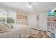 Comfortable bedroom with a queen bed, bright window, and dual closets, creating a relaxing space at 483 N Pine Meadow Dr, Debary, FL 32713