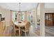 Elegant dining area featuring a large table with seating for six, wood floors and natural light at 483 N Pine Meadow Dr, Debary, FL 32713