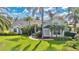 Beautiful single-Gathering home with lush landscaping and mature palm trees, creating a tropical feel at 483 N Pine Meadow Dr, Debary, FL 32713