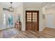 Spacious foyer with wood floors, stylish decor, and a decorative front door that leads into the home at 483 N Pine Meadow Dr, Debary, FL 32713