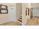 Neutral toned hallway showcasing wall decor, wood-look flooring, and door detail with warm, inviting atmosphere at 483 N Pine Meadow Dr, Debary, FL 32713