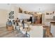 Kitchen view highlighting the breakfast bar, stainless steel refrigerator, and decorative upper shelving at 483 N Pine Meadow Dr, Debary, FL 32713