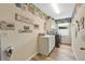 Functional laundry room with ample counter space, storage cabinets, and modern appliances at 483 N Pine Meadow Dr, Debary, FL 32713