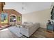 Comfortable living room with a brick accent wall, large windows, and a neutral color palette at 483 N Pine Meadow Dr, Debary, FL 32713