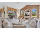 Spacious living room featuring a brick accent wall, sliding glass doors, and comfortable seating at 483 N Pine Meadow Dr, Debary, FL 32713