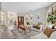 Bright living room featuring a decorative wall, neutral furniture, wood flooring, and large windows at 483 N Pine Meadow Dr, Debary, FL 32713