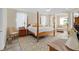 Main bedroom boasts a four-poster bed, tray ceiling, and sitting area, providing a tranquil retreat at 483 N Pine Meadow Dr, Debary, FL 32713