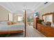 Bright main bedroom features a four-poster bed, ample closet space, and access to the backyard at 483 N Pine Meadow Dr, Debary, FL 32713