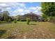 Spacious backyard with a well-manicured lawn, mature trees, and an enclosed screened lanai at 484 Lanarkshire Pl, Apopka, FL 32712