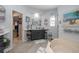 Well-lit bathroom featuring a vanity, a large tub, and a walk-in closet for storage at 484 Lanarkshire Pl, Apopka, FL 32712