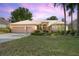Charming single-story home with a well-manicured lawn, beautiful landscaping, and a two-car garage at 484 Lanarkshire Pl, Apopka, FL 32712