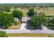 Well-maintained single-story home featuring a manicured lawn, driveway, and mature trees at 484 Lanarkshire Pl, Apopka, FL 32712