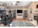 Comfortable living room with hardwood floors, a fireplace, and built-in shelving for storage and display at 484 Lanarkshire Pl, Apopka, FL 32712