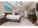 Airy main bedroom featuring a ceiling fan, large windows, and carpeted floors at 484 Lanarkshire Pl, Apopka, FL 32712