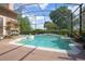 Outdoor pool with crystal-clear water, a decorative fountain, and an enclosed screened lanai at 484 Lanarkshire Pl, Apopka, FL 32712