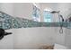 Modern shower with mosaic tile accents, rainfall showerhead, and stylish fixtures at 484 Lanarkshire Pl, Apopka, FL 32712