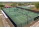 Aerial view of multiple tennis courts with lush landscaping and well-maintained surfaces at 484 Lanarkshire Pl, Apopka, FL 32712