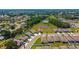 Aerial view of a home in a residential community with water and lush green surrounding at 5064 Meadow Song Dr, Okahumpka, FL 34762