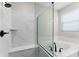 Modern bathroom features a glass enclosed shower, soaking tub, and marble tile at 5064 Meadow Song Dr, Okahumpka, FL 34762