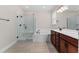 Bright bathroom showcases a double vanity, soaking tub, and glass shower at 5064 Meadow Song Dr, Okahumpka, FL 34762