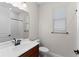 Neutral bathroom featuring vanity, window, toilet, shower with white subway tiles, and matte black fixtures at 5064 Meadow Song Dr, Okahumpka, FL 34762