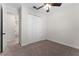 Carpeted bedroom with a ceiling fan and a closet with double doors at 5064 Meadow Song Dr, Okahumpka, FL 34762
