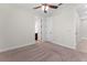Carpeted bedroom with a ceiling fan and two doorways at 5064 Meadow Song Dr, Okahumpka, FL 34762