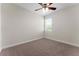 Carpeted bedroom featuring a ceiling fan, window, and neutral walls at 5064 Meadow Song Dr, Okahumpka, FL 34762