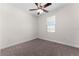 Cozy bedroom features neutral carpet, a ceiling fan, and a window letting in natural light at 5064 Meadow Song Dr, Okahumpka, FL 34762