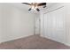 Neutral bedroom featuring a ceiling fan and a large closet at 5064 Meadow Song Dr, Okahumpka, FL 34762