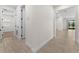 Hallway with stylish tile flooring, leading to the bedrooms and living spaces at 5064 Meadow Song Dr, Okahumpka, FL 34762
